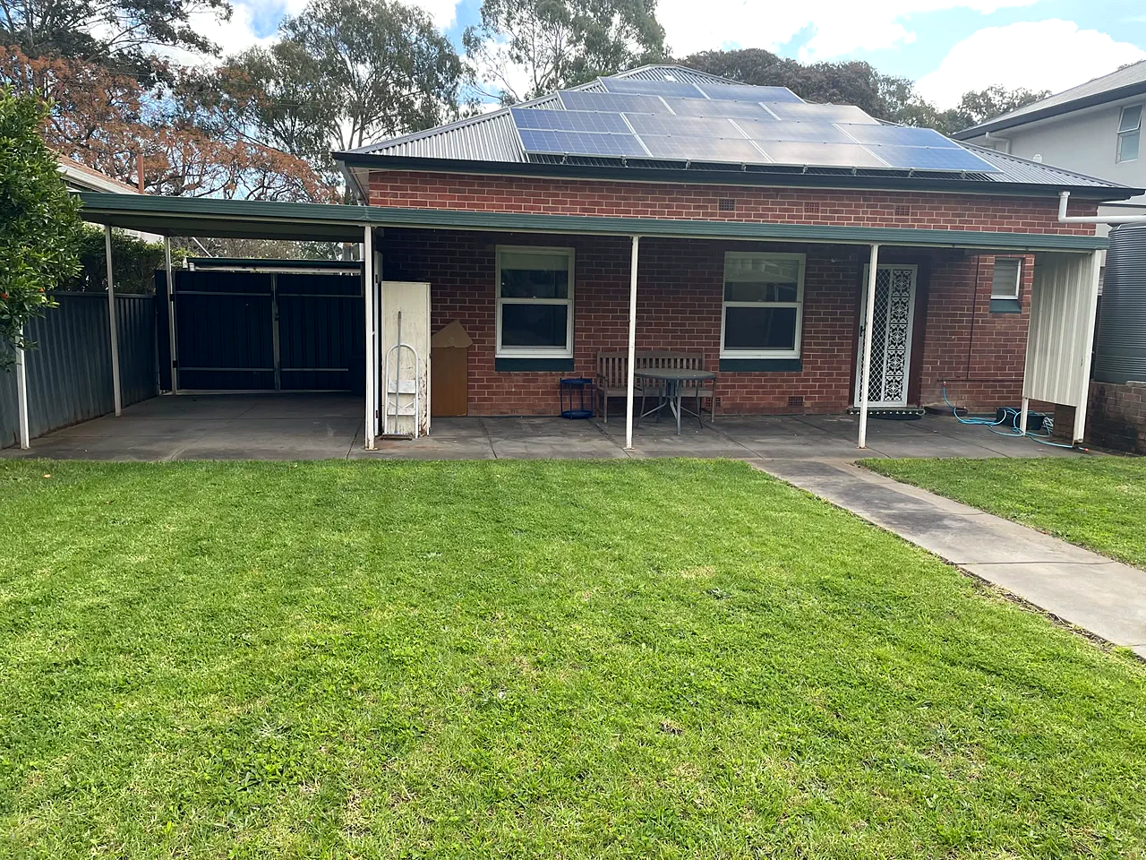 Neatly mowed backyard beside a brick home